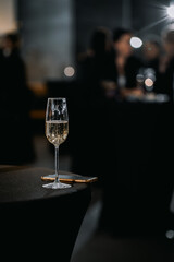 a glass of champagne and a telephone on a black table