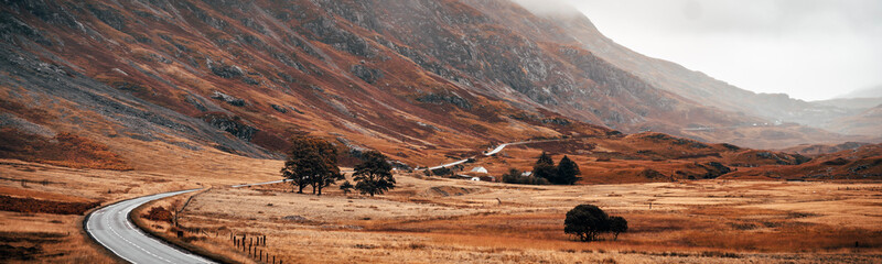 Winding road panoramic surrounded by the mountains of Glencoe, Scotland - obrazy, fototapety, plakaty