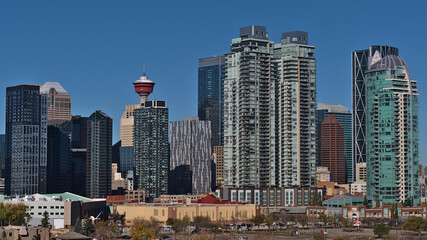 Fototapeta na wymiar Beautiful view of the downtown of Calgary, Alberta, Canada with skyline of modern high-rise buildings on sunny day in autumn season with blue sky.
