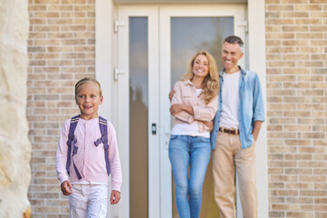 Parents sending a girl to school in the morning