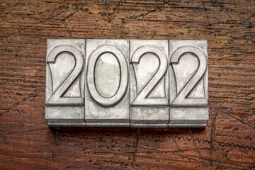 2022 year typography - number abstract in grunge  letterpress metal type against rustic, weathered wood, New Year concept