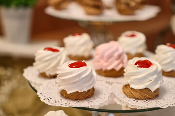 Cakes with cream and cherry jam.