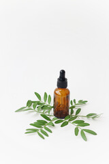 Cosmetic oil on a background of green leaves