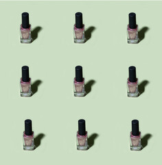 Obraz premium Pink glitter nail polish pattern on basil green background Harsh shadow. Aesthetic minimal hipster modern background