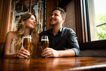 couple drinking beer in bar
