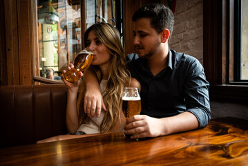 couple drinking beer in bar