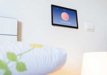 Smart home tablet with wifi icon on wall