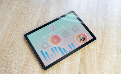 Futuristic smart home tablet on wooden table