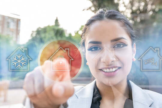 Smiling businesswoman pointing at house icon with padlock