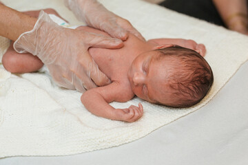 Physiotherapist working with a newborn in a medical center.