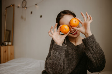 woman with mandarins at home