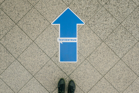 Feet in front of arrow on footpath