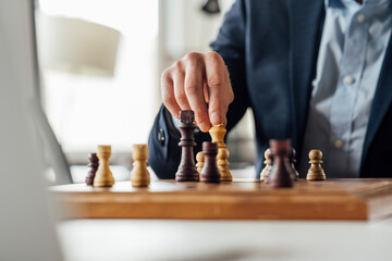 Businessman playing chess in office