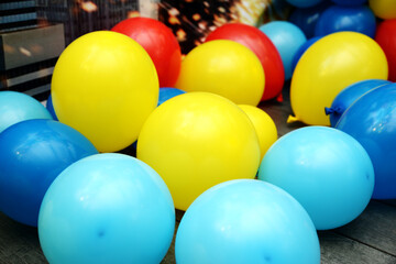 Beautiful background with yellow and blue balloons. A group of balls. The concept of happiness, joy, birthday. Wide angle holiday banner.