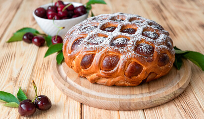 American cherry pie on rustic wooden board fresh cherry berries on background. Easy recipe of berry dessert for everyday cooking. Fruit cake with flaky crust. Homemade bakery by classic recipe.