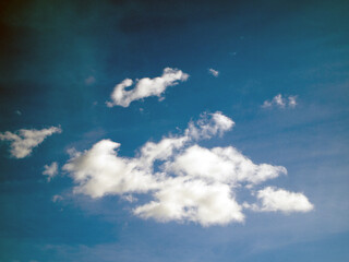 Bottom view of a cloudy muted sky on a windy day. The clouds are blurry due to fast movement. The sky at once several shades of blue (turquoise, teal, navy, royal, space, prussian, yale).