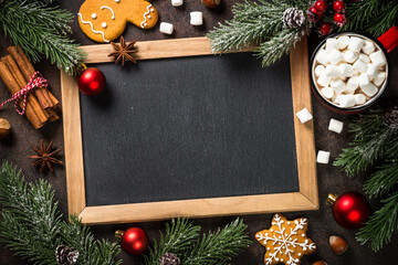 Christmas bcooking background at dark table. Christmas cookies with hot chocolate and spices. Top view with space for recipe.