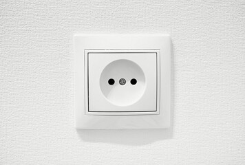Common cheap plastic AC power wall socket. German circular recess socket with two round holes for 2...