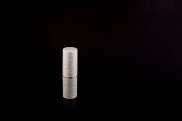 silver matte lipstick bottle on black background side view