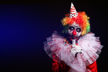 Terrifying clown on dark background, space for text. Halloween party costume