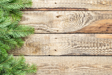 Christmas tree green branches on a wooden background. Decorations for Christmas and New Year. Top view, copy space