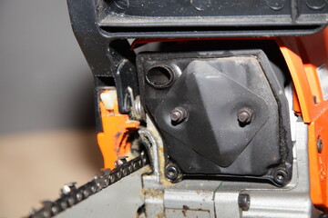 Clear chainsaw exhaust pipe on silencer muffler closeup - power tools equipment maintenance