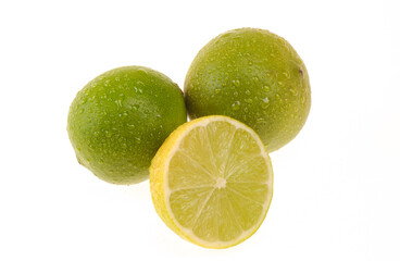 Lemons being one cut in half on white background.