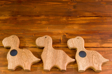 Wooden background - wooden dinosaurs on a wooden surface.