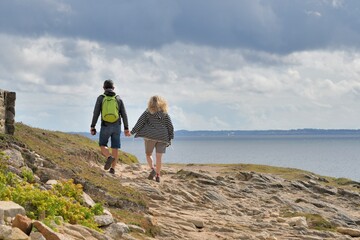 People,walking along the wild coast at the Quiberion peninsula in Brittany France