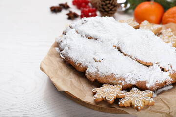 Fototapeta na wymiar Traditional Christmas Stollen with icing sugar on white wooden table