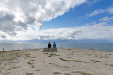 Couple sitting in front of the sea at the Quiberon peninsula. Brittany - France