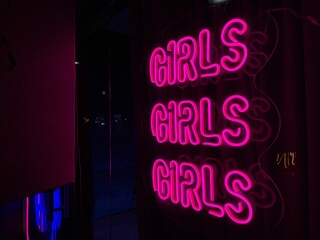 Girls neon sign glowing pink at night