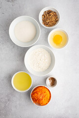 Fototapeta na wymiar Ingredients for a pie on a light background. Wheat flour, olive oil, walnuts, sugar, egg, cinnamon, spices