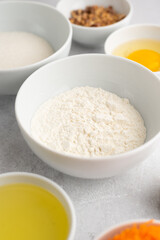 Obraz na płótnie Canvas Ingredients for a pie on a light background. Wheat flour
