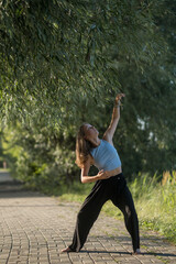 Fototapeta na wymiar Girl dancing in the park