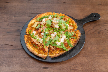 Exotic pizza recipe with pineapple, arugula, goat cheese and roast chicken