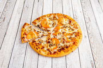 Freshly made pizza with ingredients and kebab or shawarma meat with cheese, peppers and lots of onions and cooked in a stone oven.