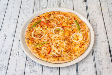 Freshly made pizza with ingredients and kebab meat or shawarma with cheese and cooked in a stone oven