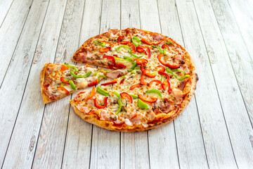 Delicious and colorful stone oven pizza with red and green peppers and mozzarella cheese with bacon