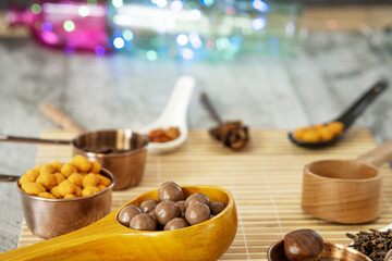 Still life with chocolates, nuts and decorative colored lights
