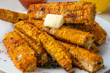 Grilled corn with paprika, pepper and garlic with a slice of melted butter. Close-up. Selective...