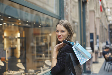 Fototapeta premium young woman with shopping bags in the city