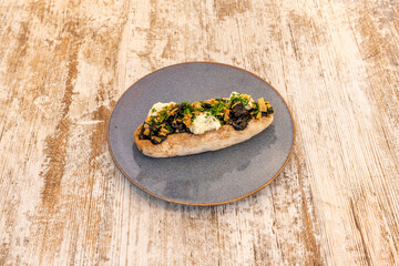 New style puppy with squid stew in its ink on a gray porcelain plate