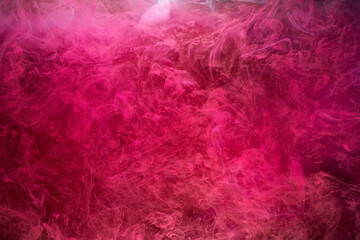 Pink smoke on black ink background, colorful fog, abstract swirling touch ocean sea, acrylic paint pigment underwater