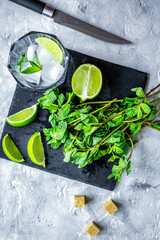 making mojito on stone background top view
