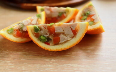 appetizer of jellied chicken with vegetables in orange close up selective focus
