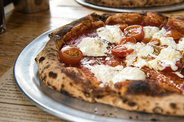 artisan margarita pizza with tomato and mozzarella cheese