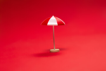 Red umbrella on a red background.