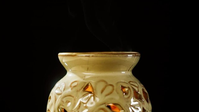 Candle holder close-up. Making aroma candles, oil diffuser on black background. Perfume for home, relaxing and spa concept. 