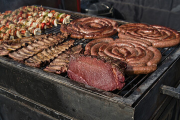 barbecue with meat, sausages and skewers